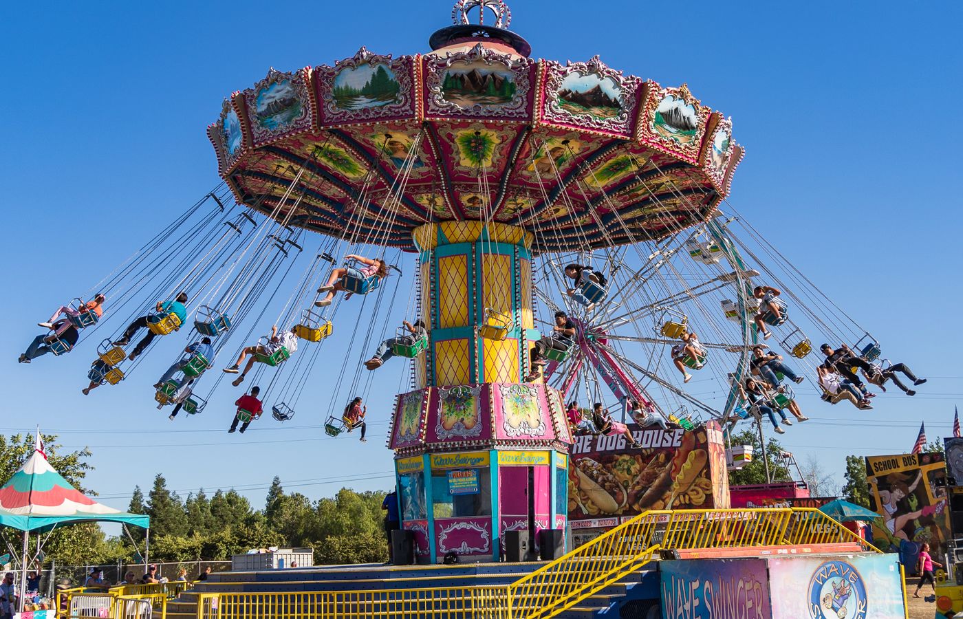 Illuminated ferris wheel and carnival rides at dusk during the Georgia Mountain Fair in Hiawassee