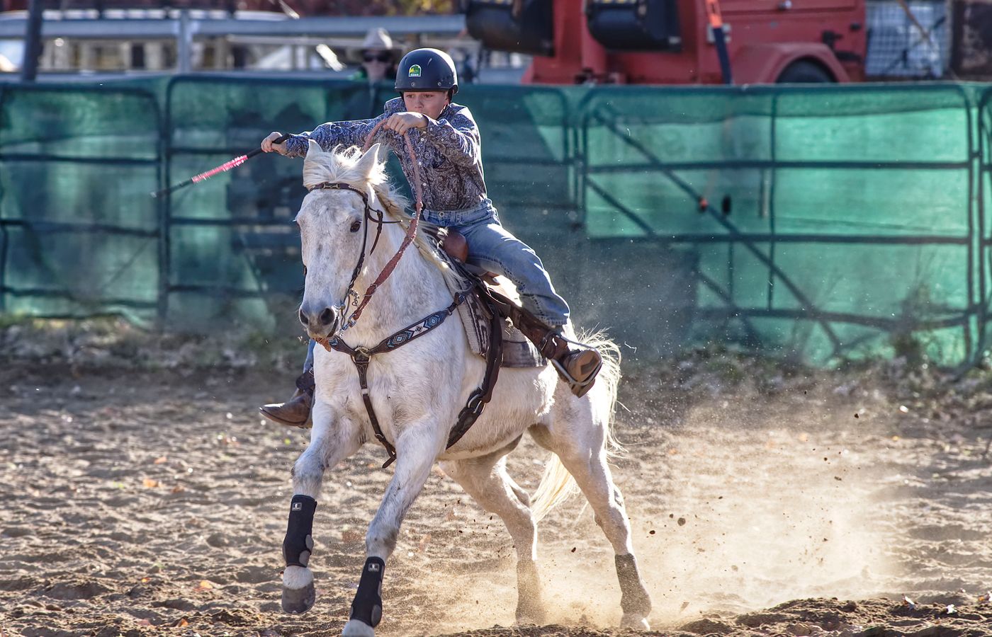 Rider on horseback racing through a dusty arena at the Hiawassee Pro Rodeo in Georgia